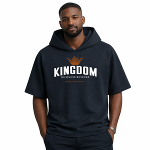 Man wearing a black hoodie with 'Kingdom Business Builder' text on a white background